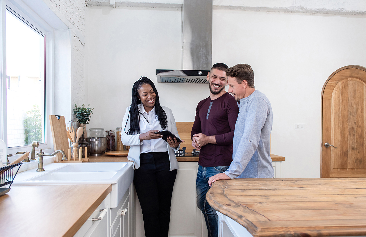 Couple reviewing mortgage paperwork with a lender, working through options with clear documentation.