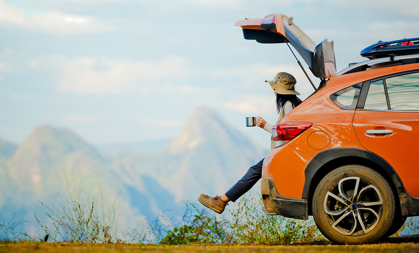 Person smiling in a convertible, suggesting an enjoyable vehicle experience.