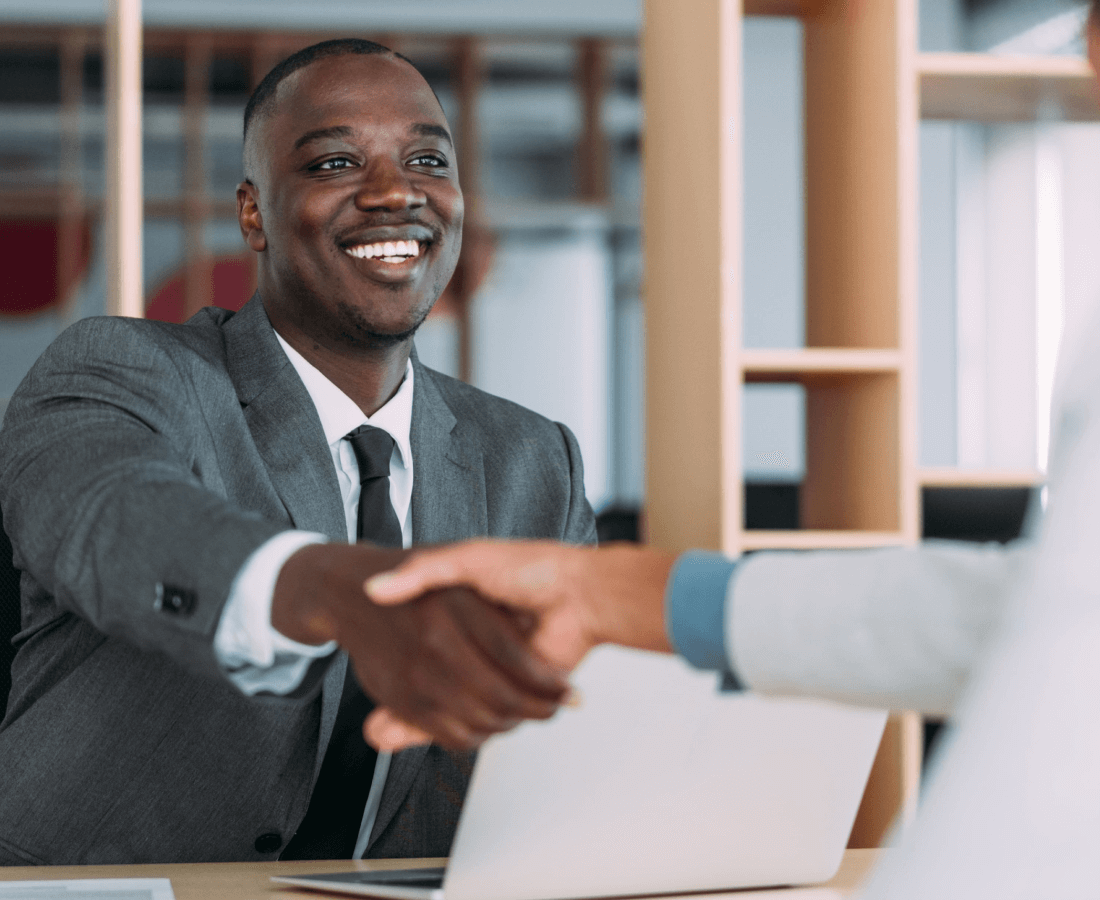 Business owner shaking hands after a successful meeting.